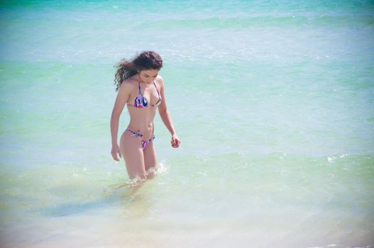 Beautiful fit model wearing a thong bikini at the gorgeous blue water beaches of florida on vacation