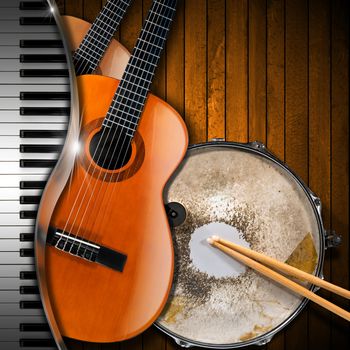 Two acoustic guitars, piano keyboard and metallic old snare drum against a rustic wood background. Concept of music performance