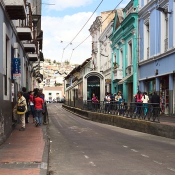 QUITO, ECUADOR - AUGUST 4, 2014: Unidentified people on Juan Jose Flores street in the city center at the trolley bus stop Plaza del Teatro on August 4, 2014 in Quito, Ecuador. Quito is an UNESCO World Cultural Heritage Site. 