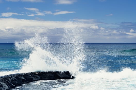 Tall waves crashing on the coastline of the ocean