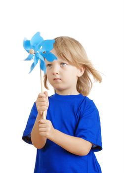 boy with long blond hair in blue top playing with a pinwheel - isolated on white