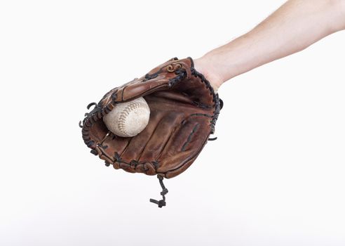hand with a baseball glove with the ball in it - isolated on white