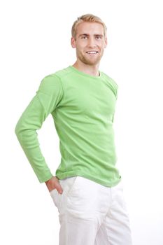 portrait of a young man with blond hair in green top smiling - isolated on white