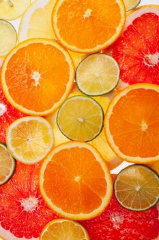 background of different colored slices of citrus fruits close up