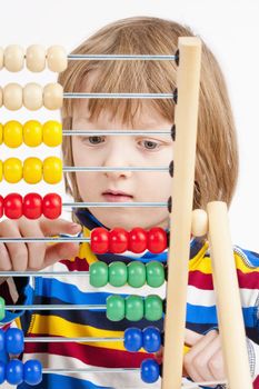 Boy Counting on Colorful Wooden Abacus - Isolated on White