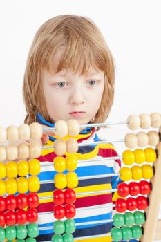 Boy Counting on Colorful Wooden Abacus - Isolated on White