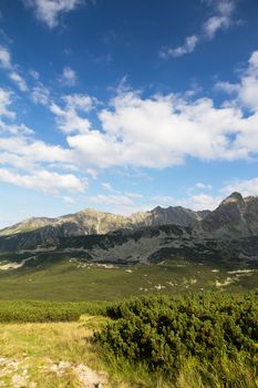 view on mountais in summer and blue sky with clouds