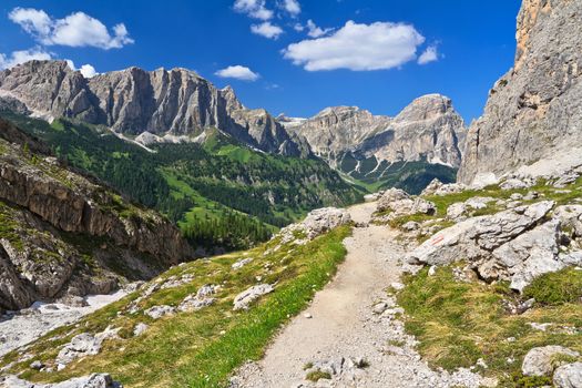 footpath in high Badia Valley, on background Sassongher mount, Alto Adige, Italy