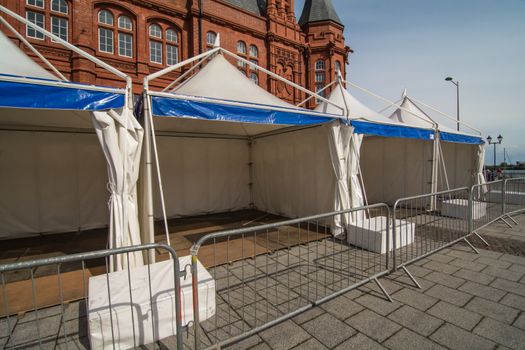 A row of static display tents, in readiness for a public event