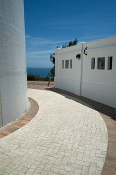 A close up of a path around Gibbs Hill Lighthouse, Bermuda, set against a blue sky