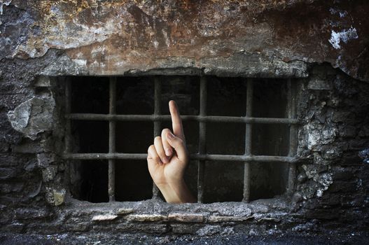 Conceptual image of a hand reaching out from a dungeon.