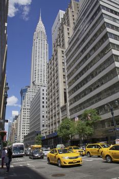 NEW YORK - JUNE 06: Empire State Building close up view June 06, 2014. Famous landmark and yellow cabs in busy New York City, USA