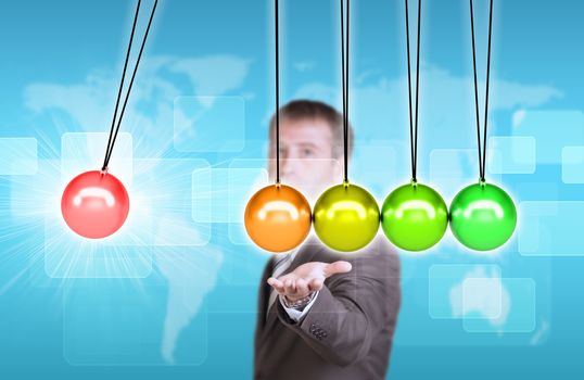 Businessman in suit hold Newtons cradle. World map and rectangles as backdrop