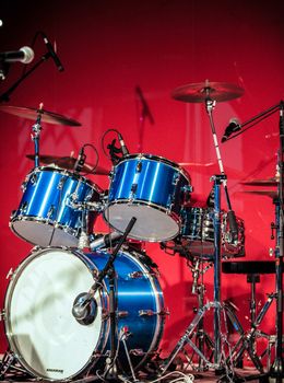 Red Drumkit in front of Blue Background