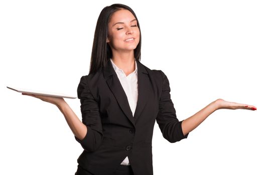 Beautiful businesswomen in suit hold tablet and empty palm. Smiling and closed her eyes. Isolated on white background