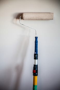 Closeup of a Paint Roller on the Wall