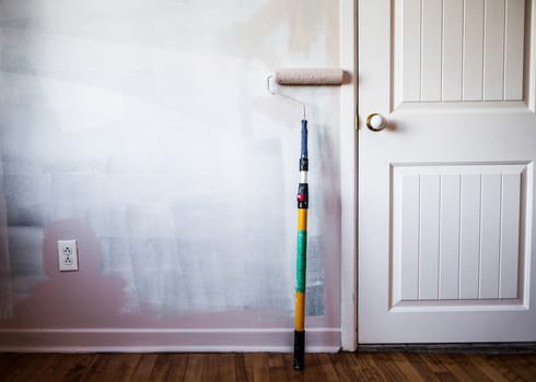 Closeup of a Paint Roller on the Wall