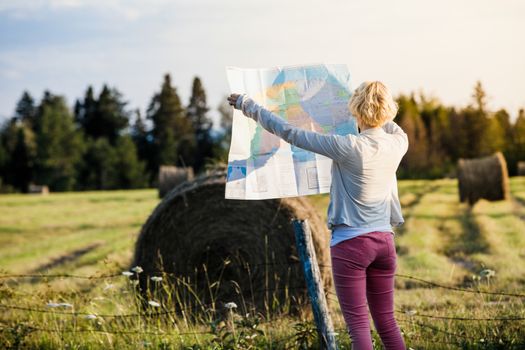 Lost Young Woman on a Rural Scene Looking at a Map