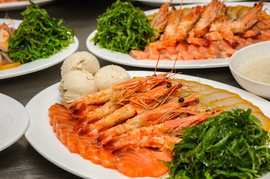 Prepared shrimps, chuka and Vorschmack on plates ready to be served in restaurant