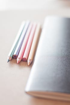 Color pencils with black notebook, stock photo
