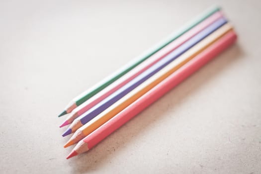Closeup colorful pencils on wooden background, stock photo