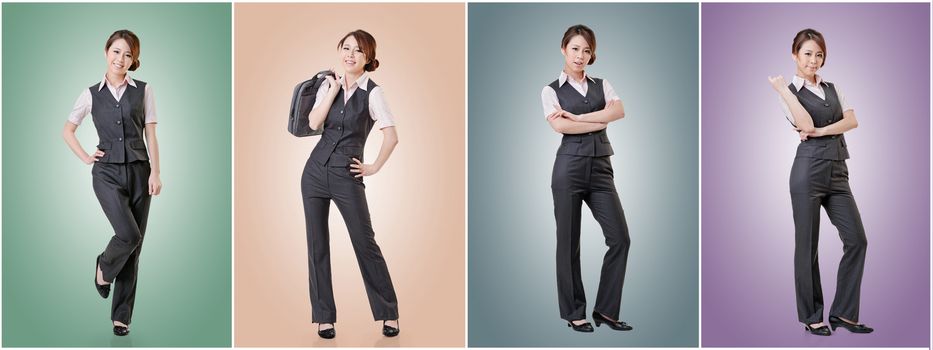 Asian business woman standing against studio background, full length portrait in a set.