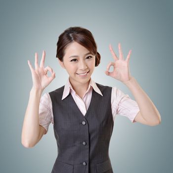Asian business woman give you OK gesture, close up portrait with clipping path.