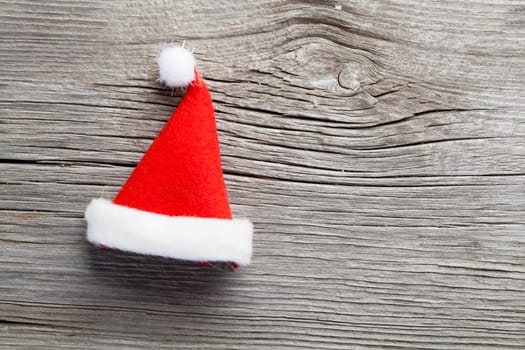 Single Santa Claus red hat on wooden background