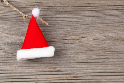 Single Santa Claus red hat on wooden background