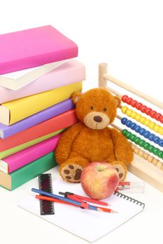 stack of books, teddy bear and abacus