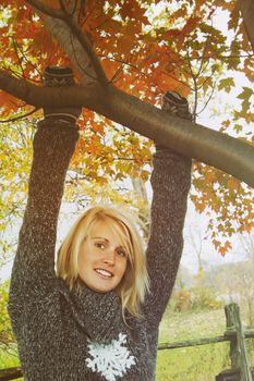 Woman hanging on branch in autumn