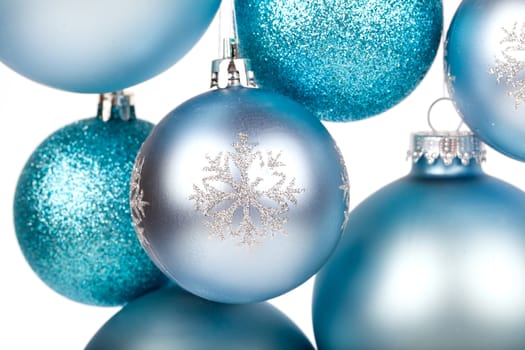 blue christmas balls hanging isolated on white