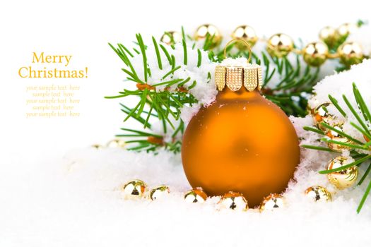 orange xmas baubles on white snow