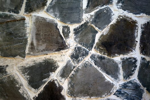 The wall of the large gray-brown stones close-up