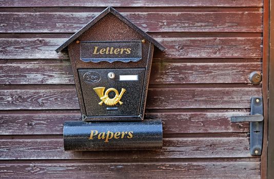 Mailbox on a wooden gate close-up 