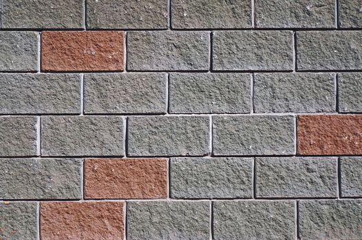 The wall of the large gray and red rectangular stones as background