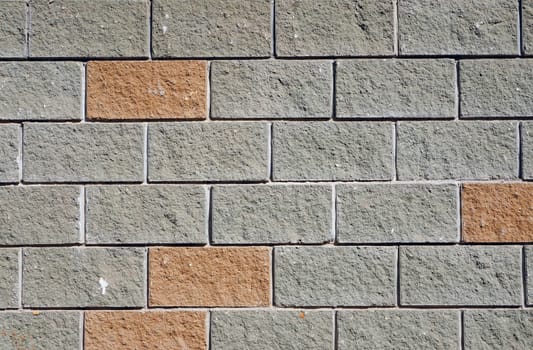 The wall of the large gray and red rectangular stones as background 