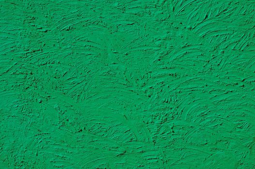 The texture of green walls painted large erratic strokes of paint                                  