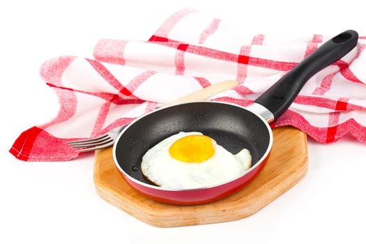 Fried egg in a frying pan, over white background