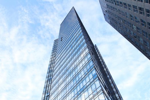 glass wall of office building,with reflection of clouds