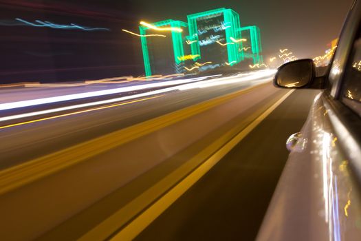 driving car in the night, view from side of car,blurred motion