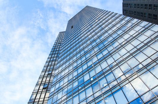 glass wall of office building,with reflection of clouds
