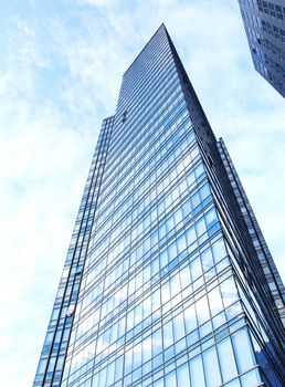 glass wall of office building,with reflection of clouds