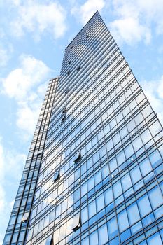 glass wall of office building,with reflection of clouds