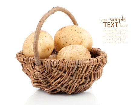 Golden Potatoes in wicker basket over white background