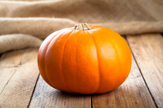 Autumn pumpkins on wooden board