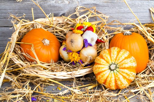 Autumn pumpkins on wooden board, straw