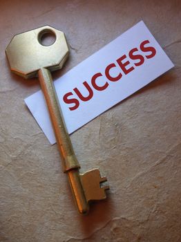 Success label and golden key close up