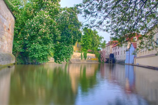 Photo shows general view of Prague Kamap park and Vltava river.