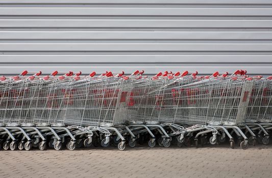 number of metal carts at supermarket wall